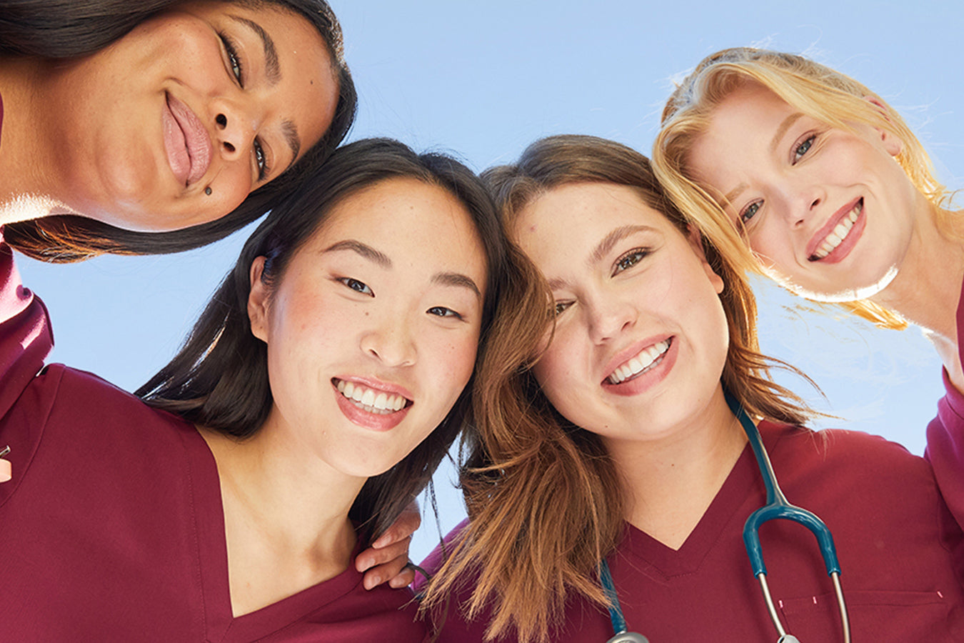 Group of young healthcare professionals smiling while wearing comfortable scrubs during long shifts