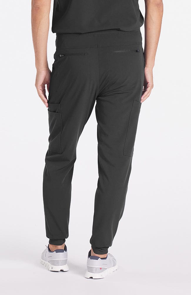 A man wearing Andre 8-Pocket Men's CORE Scrub Jogger Pant in Charcoal 