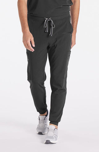A man wearing Andre 8-Pocket Men's CORE Scrub Jogger Pant in Charcoal 