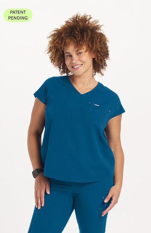 Woman in caribbean blue Cypress two pocket scrub top from DOLAN