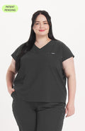 Woman in v neck scrub top with drop shoulder and 2 pockets in charcoal