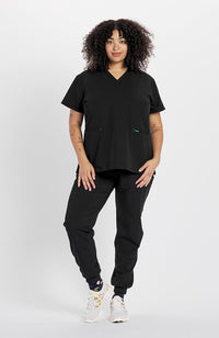 Woman in V neck scrub top with two pockets kangaroo in black