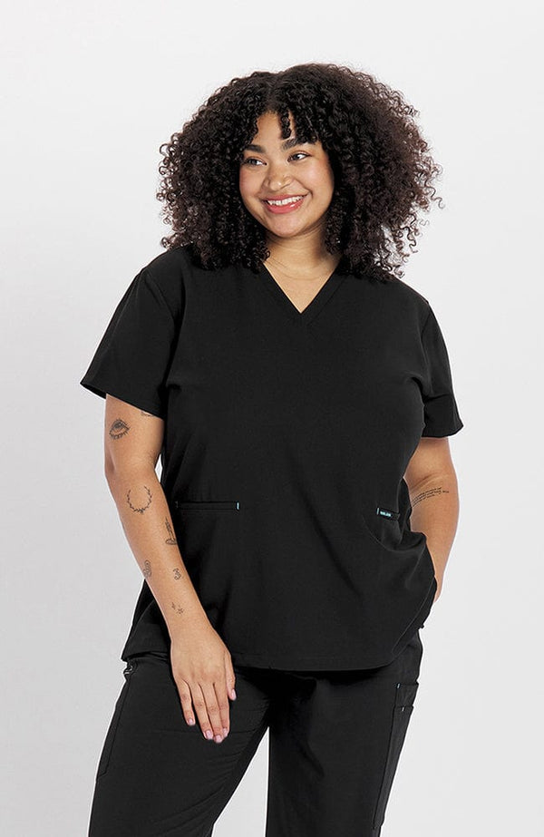 Woman in V neck scrub top with two pockets kangaroo in black