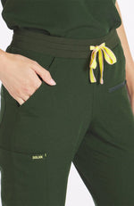 Woman wearing dark olive Hope 11 pocket joggers from DOLAN