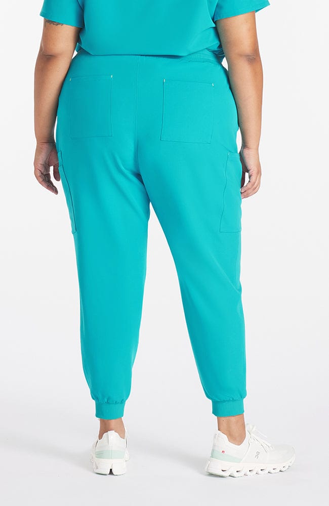 Super comfortable teal colored scrub pants with 11 pockets on woman