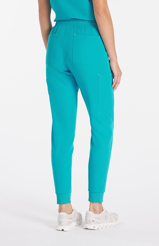 Super comfortable teal colored scrub pants with 11 pockets and V neck top on woman