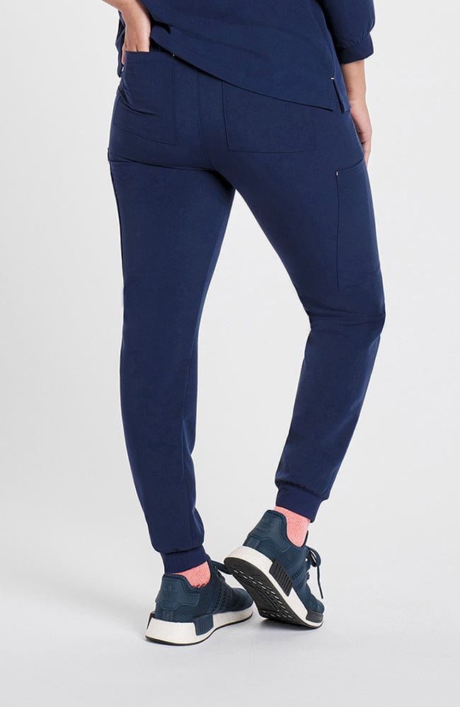 Woman in high waisted Hope 11 Pocket Jogger scrub pant in Navy
