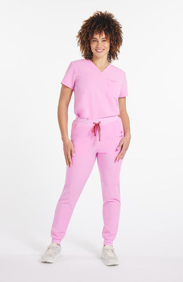 Woman wearing Hope 11-Pocket CORE Scrub Jogger Pant in Brilliant Lilac