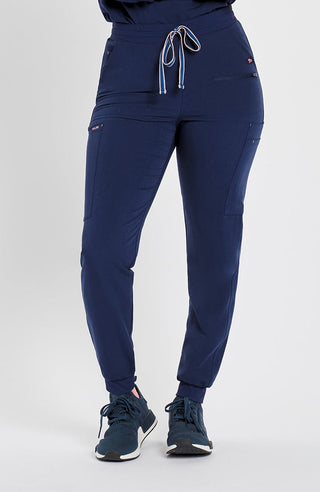 Woman in high waisted Hope 11 Pocket Jogger scrub pant in Navy