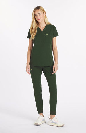 Woman wearing dark olive the Mayfair 2 pocket scrub top from DOLAN