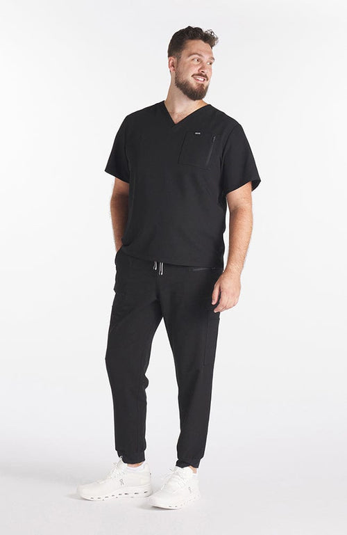 Man wearing black Miguel V Neck 3-Pocket Men's CORE Scrub Top - DOLAN