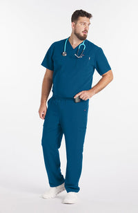 Man wearing Caribbean Blue Miguel V Neck 3-Pocket Men's CORE Scrub Top - DOLAN