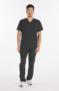 Man wearing Miguel V Neck 3-Pocket Men's CORE Scrub Top in her charcoal