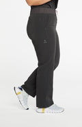 A woman wearing District high-waisted scrub pants 6-pocket CORE scrub in charcoal.