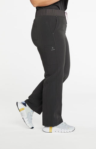 A woman wearing District high-waisted scrub pants 6-pocket CORE scrub in charcoal.