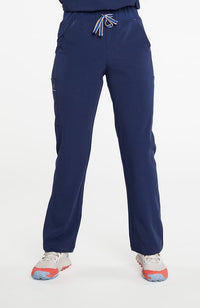 A woman wearing District high-waisted scrub pants 6-pocket CORE scrub in navy.