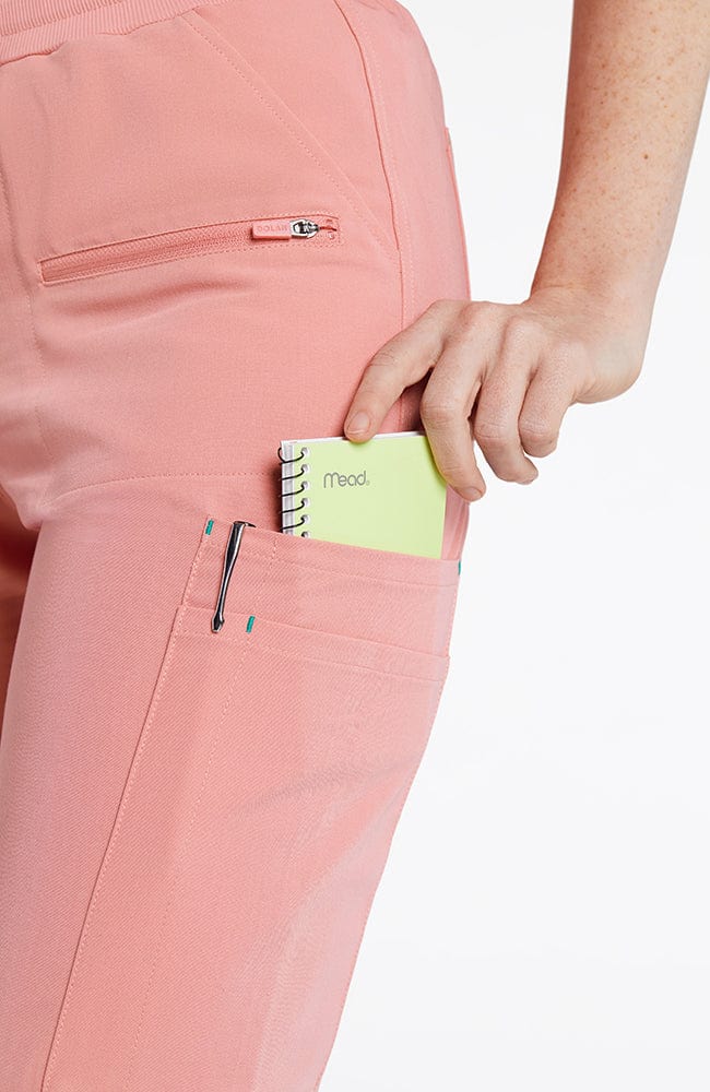 Woman in DOLAN Hope 11-Pocket CORE Scrub Jogger Pants in pink