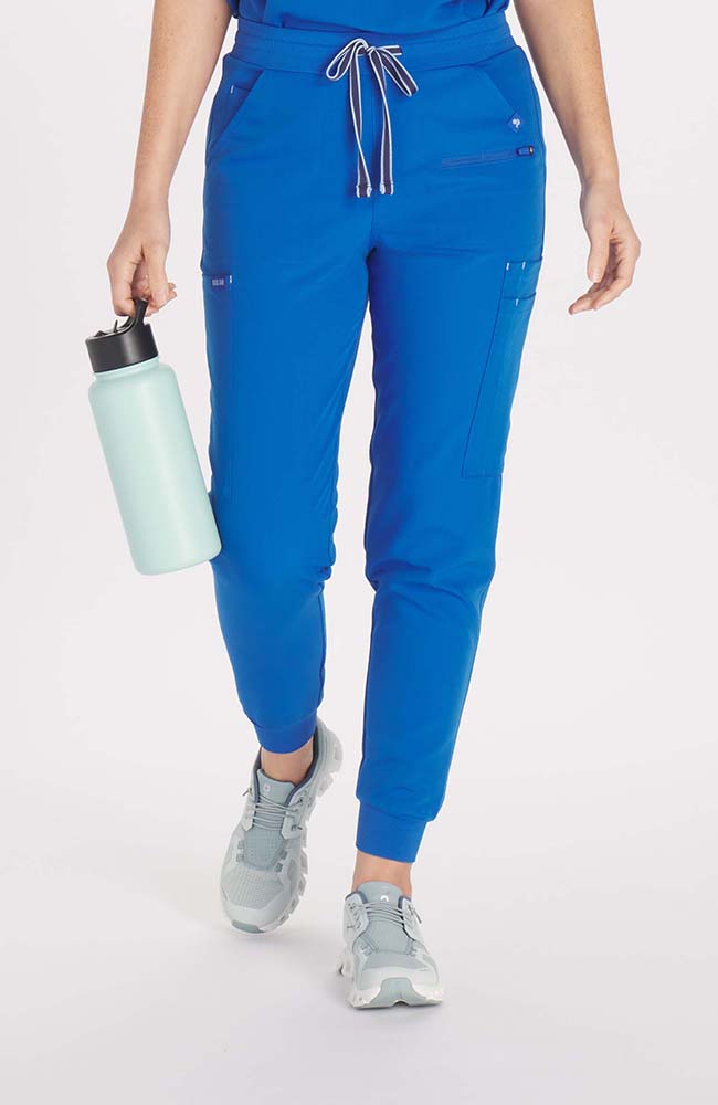 Woman wearing Hope 11-Pocket CORE Scrub Jogger Pant in Royal Blue- DOLAN