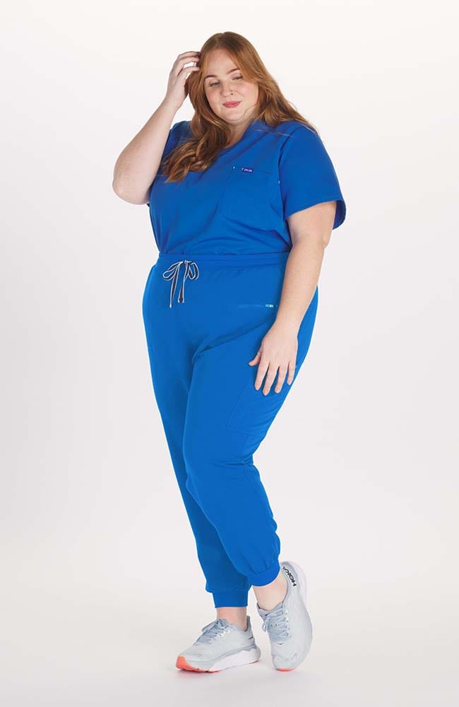 Woman wearing Hope 11-Pocket CORE Scrub Jogger Pant in Royal Blue- DOLAN
