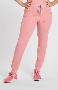 Woman in DOLAN Hope 11-Pocket CORE Scrub Jogger Pants in pink