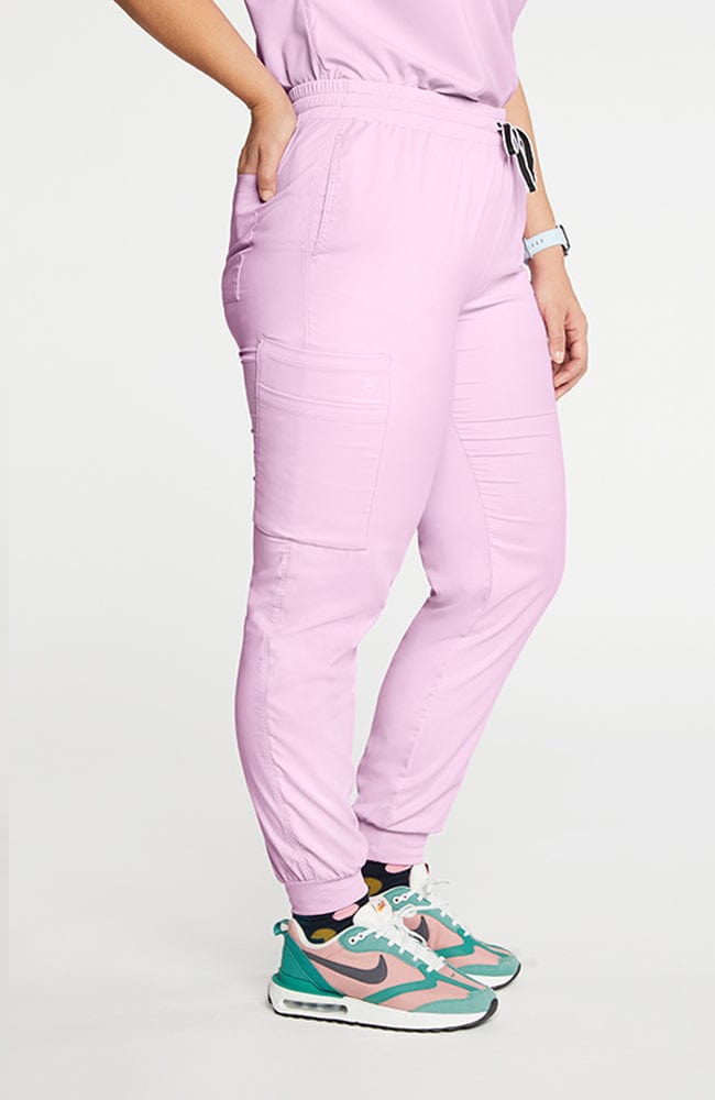 A woman wearing Huntington high-waisted jogger pants 7-pocket TLC scrub in lilac.