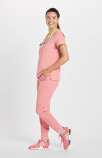 Woman in Mayfair V Neck 2-Pocket CORE Scrub Top in pink by DOLAN
