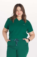 Woman in hunter green V neck scrub top DOLAN