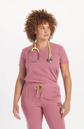 Woman in rosewood pink scrub color V neck scrub top
