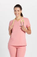 Woman in Mayfair V Neck 2-Pocket CORE Scrub Top in pink by DOLAN